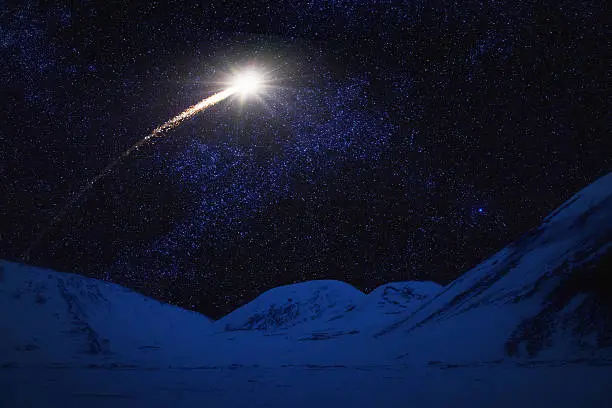 Shooting star over winter landscape.