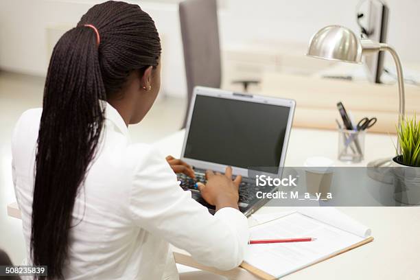 African Businesswoman Working On Lap Top Stock Photo - Download Image Now - Over The Shoulder View, Using Laptop, Using Computer