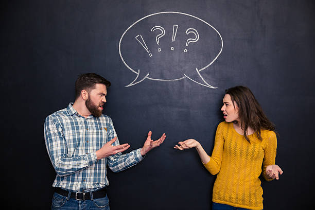 istock Unhappy couple quarreling over blackboard background 508249032