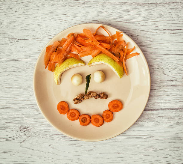 istock Vegetable face made of carrot, pear, cheese and walnuts 508250616