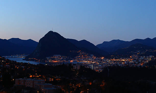 The bay of Lugano at night The bay of Lugano at night with Mount San Salvatore, Melide and Capo San Martino in the winter lugano stock pictures, royalty-free photos & images