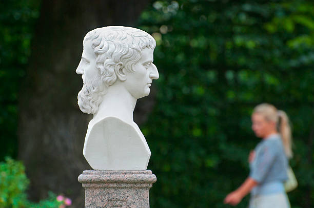 Saint-Petersburg. Russia. Girl in The Summer Garden Saint - Petersburg, Russia- July 12, 2014: Girl walk in The Summer Garden near  Janus with two Faces. The Summer Garden - park ensemble, founded by Peter the Great. Janus is the god in ancient Roman religion janus head stock pictures, royalty-free photos & images
