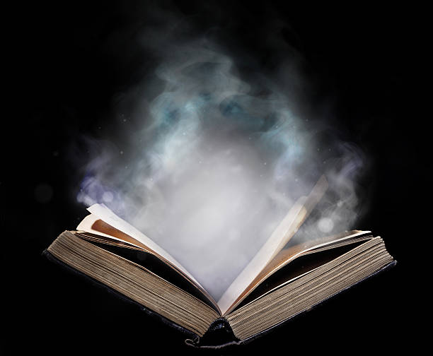 istock Ancient open book in the magical smoke 508253388