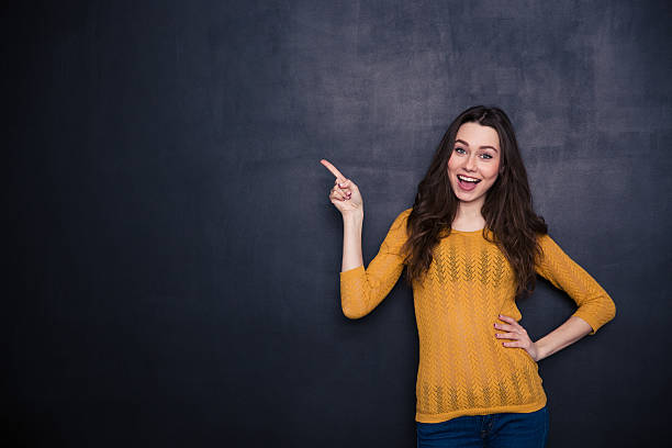 istock Cheerful casual woman pointing away 508254010