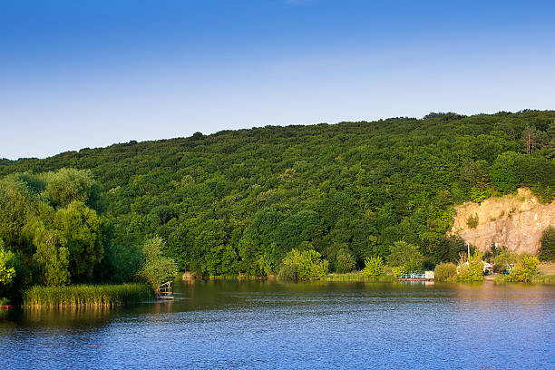 istock landscape of a hills with trees, river and sky 508255916