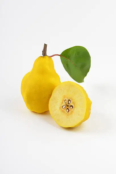 Raw quince on white background