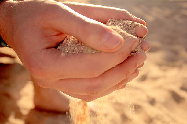 istock Hands holding sand on sunny beach on summer vacation 508258152