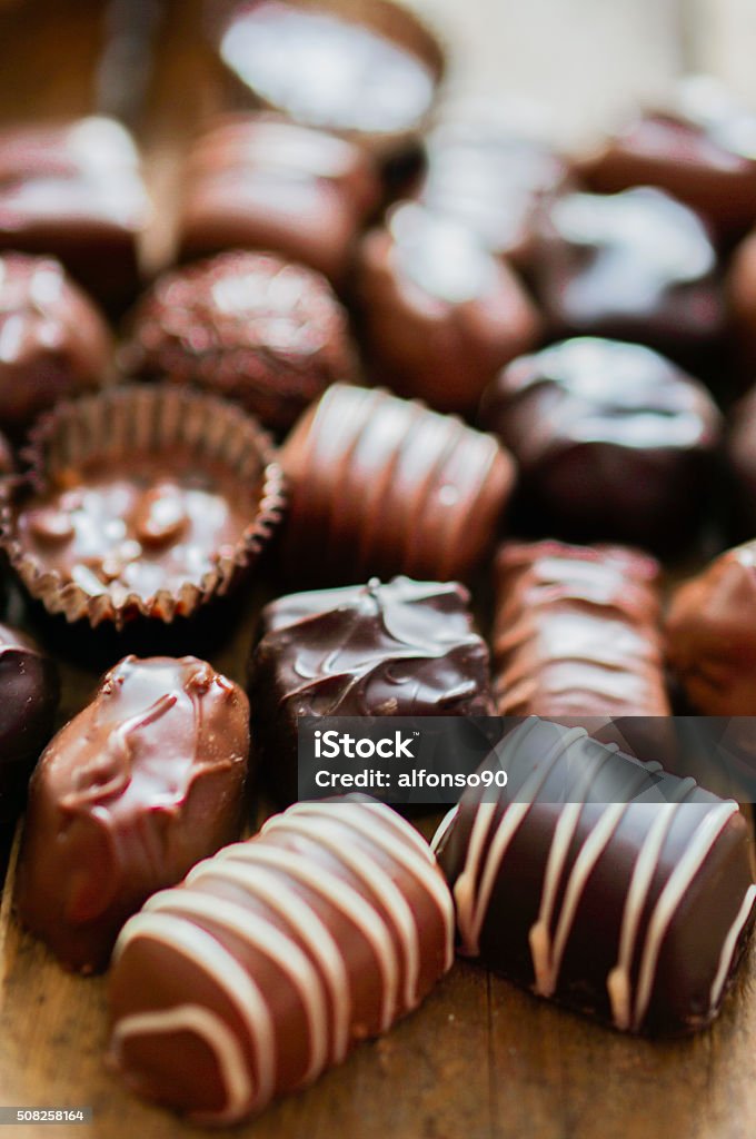 Assorted Chocolate pralines on brown background Assorted Chocolate Pralines On Brown Background Brown Stock Photo