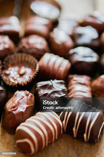 Assorted Chocolate Pralines On Brown Background Stock Photo - Download Image Now - Brown, Candy, Chocolate
