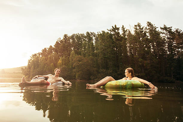 istock Young couple in lake on inflatable ring 508258248