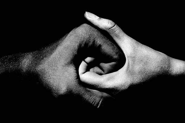 holding hands black and white hands holding together religious symbol photos stock pictures, royalty-free photos & images