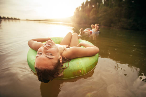 istock Young woman relaxing on inflatable ring in lake 508258366