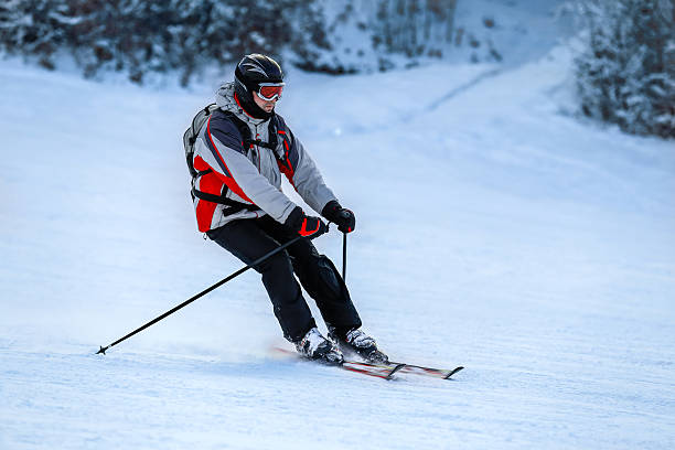 istock Skier in ski suit slides down from snow slope 508258602