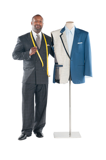 Portrait of tailor standing with mannequin