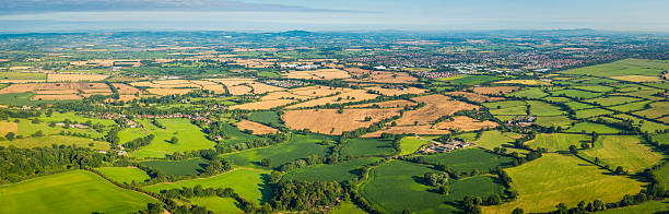 istock Aerial panorama over idyllic patchwork landscape of green fields farms 508270813