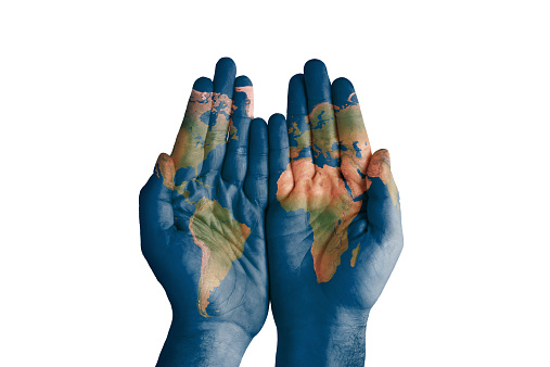 World map painted on hands.
