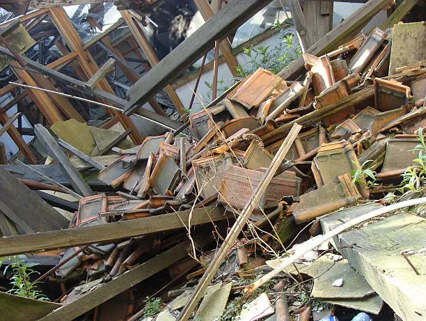 collapsed roof showing wood glass,and stone rubble