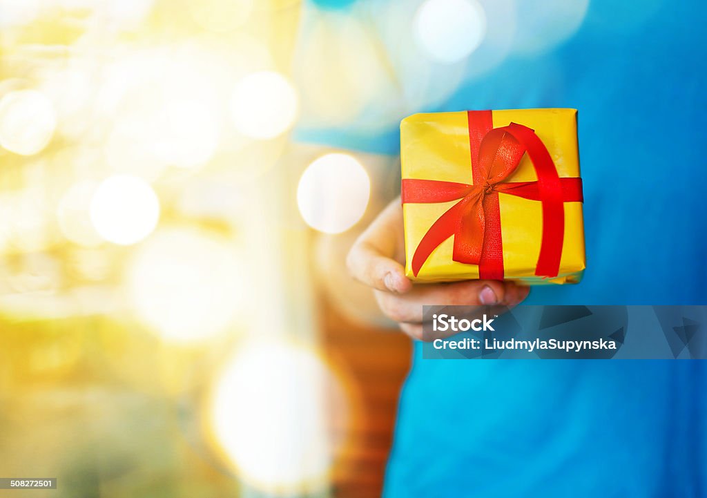 Little present A hand holding christmas present Adult Stock Photo
