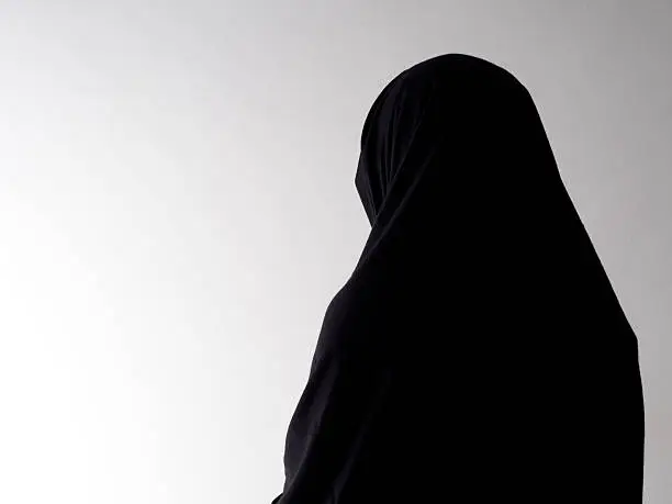 Woman in chador from behind, with copyspace
