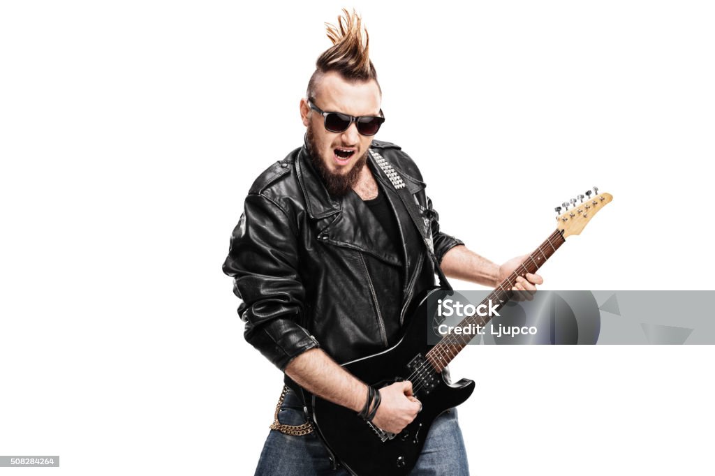 Young punk rocker playing electric guitar Young punk rocker playing electric guitar isolated on white background Rock Musician Stock Photo