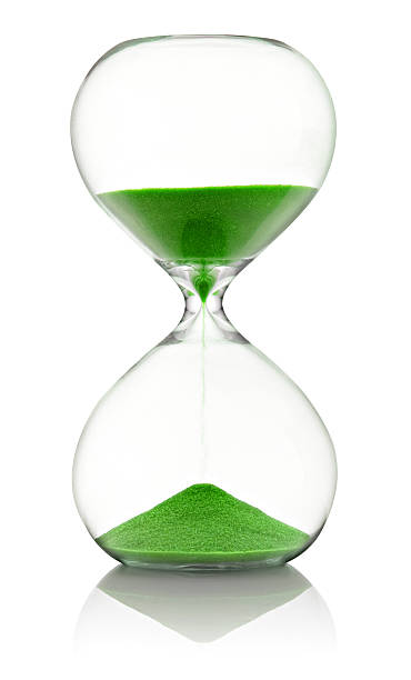 istock Hourglass with green sand running through 508285332