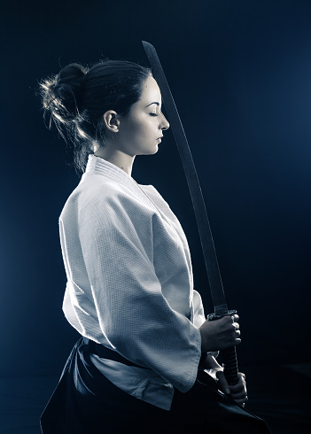 Young woman preparing for aikido training