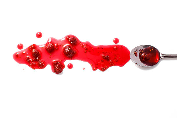 splashes of raspberry jam and a spoon with crimson jam raspberry jam and raspberries isolated on white background. flat lay, top view raspberry jam stock pictures, royalty-free photos & images