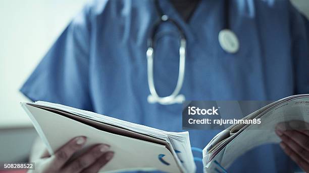 Doctor With Stethoscope And Files Stock Photo - Download Image Now - NHS, Doctor, Midwife