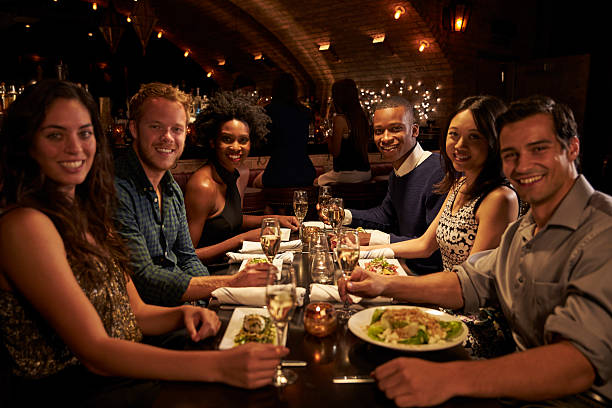 istock Group Of Friends Enjoying Meal In Restaurant 508292306