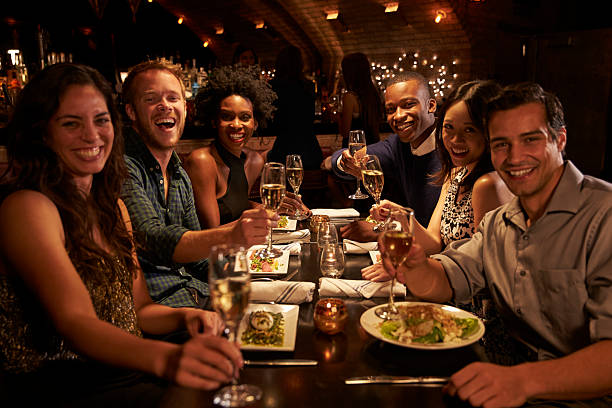 istock Group Of Friends Enjoying Meal In Restaurant 508292414