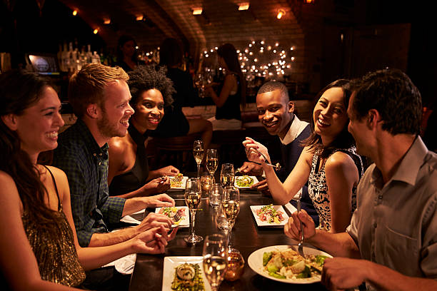 istock Group Of Friends Enjoying Meal In Restaurant 508292680