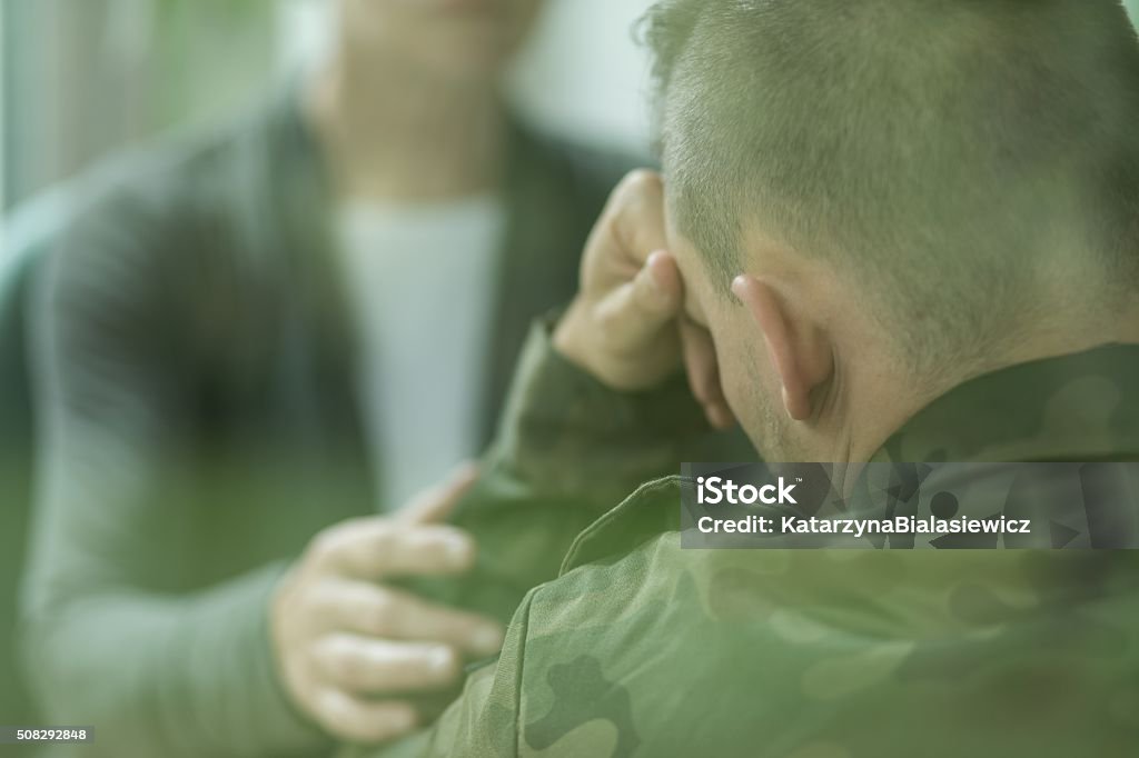 Therapist supporting her military patient Image of female therapist supporting her military patient Abuse Stock Photo