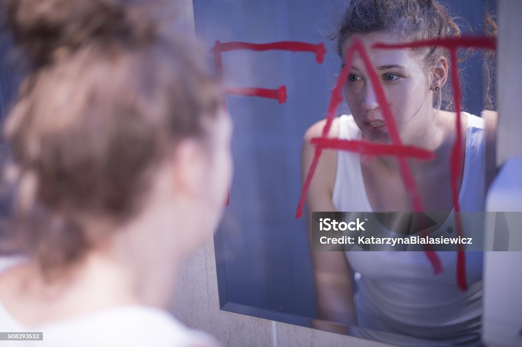 Fat writing on mirror Fat red writing on mirror and teenage girl Teenager Stock Photo