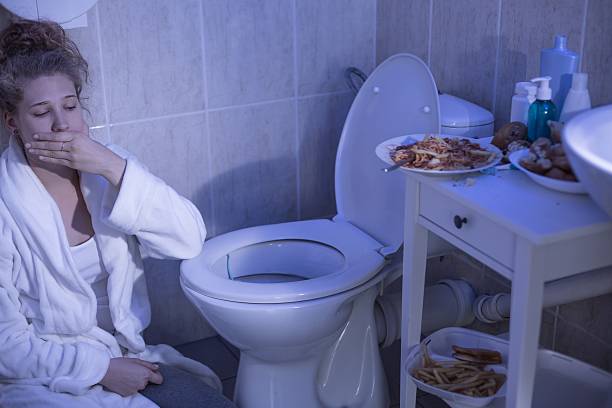 Bulimia nervosa vomiting Teenage bulimic girl vomiting in the bathroom bulimia stock pictures, royalty-free photos & images