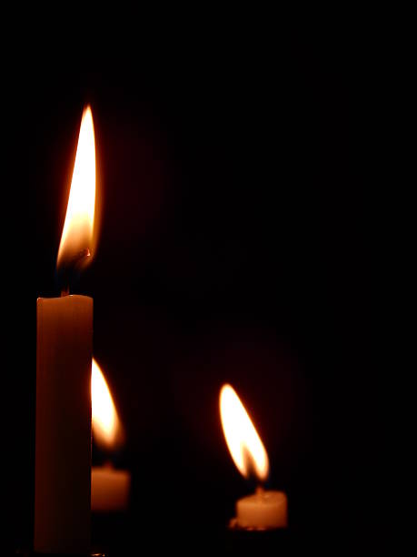 istock Three candles burning in a church 508296933