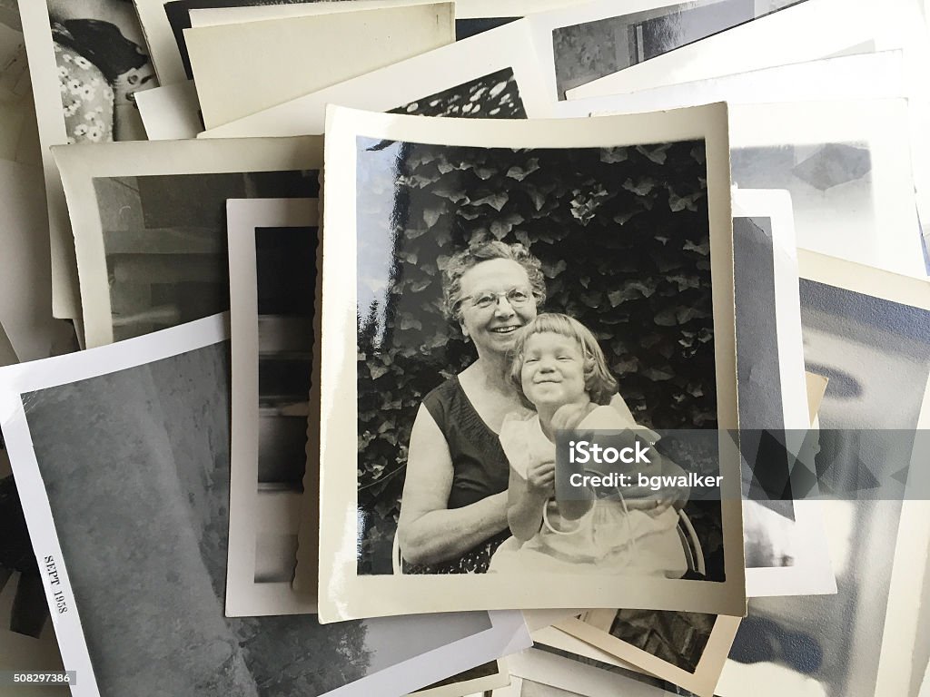 Young Girl sitting in her Grandmother's Lap Young girl sitting in her Grandmother's lap in the 1950s.     iPhone Photographic Print Stock Photo