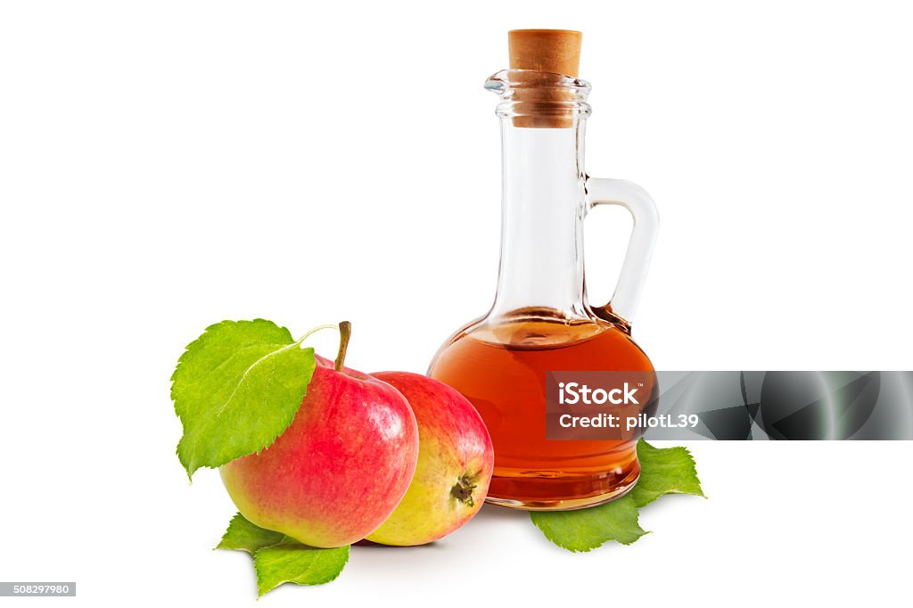 Apple vinegar Apple cider vinegar cruet and ripe apples with green leaves on a white background Apple - Fruit Stock Photo