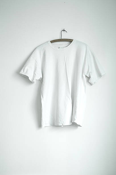 istock White t-shirt hanging on white wall 508298110