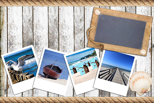 istock Timber wall with an old slate blackboard and instant pictures 508298621