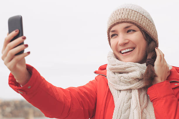 istock Young woman using mobile phone  in winter 508298766
