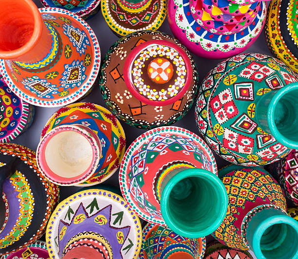 Top view showing a composition of artistic painted handcrafted pottery jars, part of the art works of Ebtessam ElGohary, a contemporary Egyptian artist specialized in pottery painting art. The piece shown in the photo was created by her in Cairo, late 2015