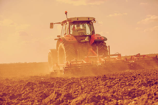 istock Farmer in tractor preparing land with seedbed cultivator. Filtered image. 508299412