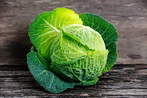 Photo of Fresh Green cabbage on old wooden table