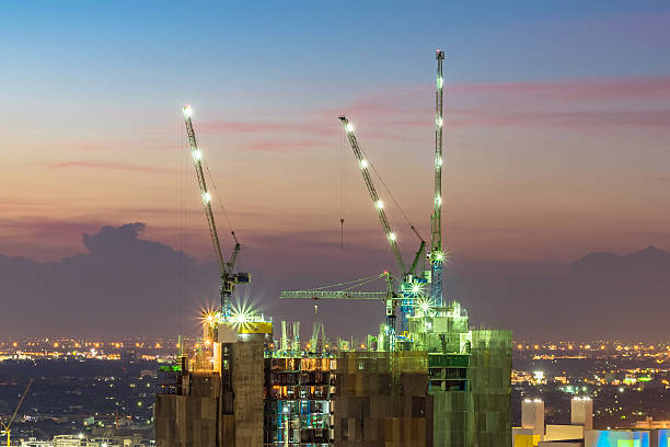 istock Industrial construction cranes at construction site with sunset sky background 508300102