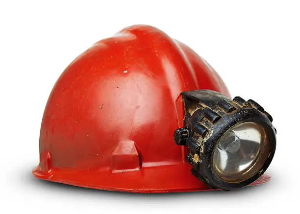 Vintage miners helmet with lamp isolated on white with soft shadow