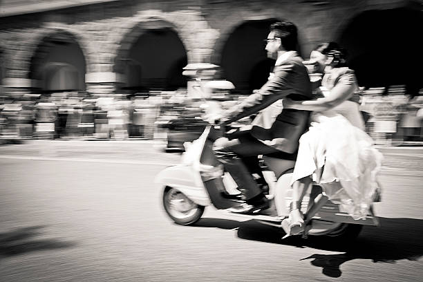 istock Bride and groom on a italian motor scooter 508301741