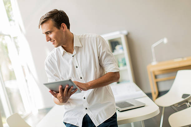 istock Young man with tablet in the office 508301939