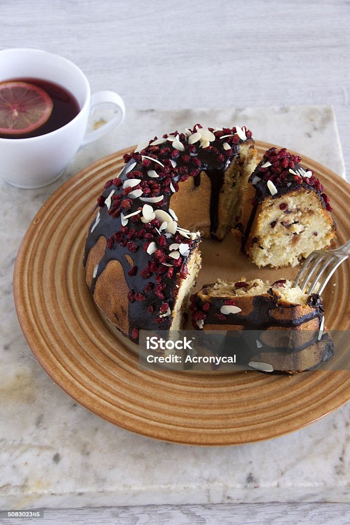 Ring Cake With Chocolate Sauce, Cranberry  and Flaked Almonds Almond Stock Photo