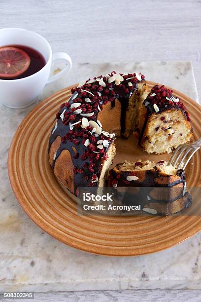 Ring Cake With Chocolate Sauce Cranberry And Flaked Almonds Stock Photo - Download Image Now