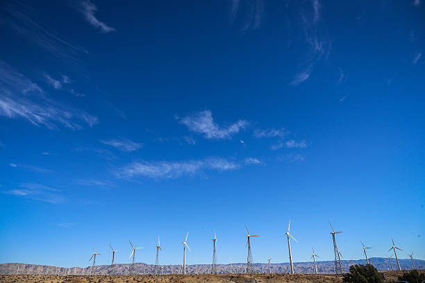 The impossibly blue sky backdrops rows of wind turbines, spinning in the Arizona desert winds.